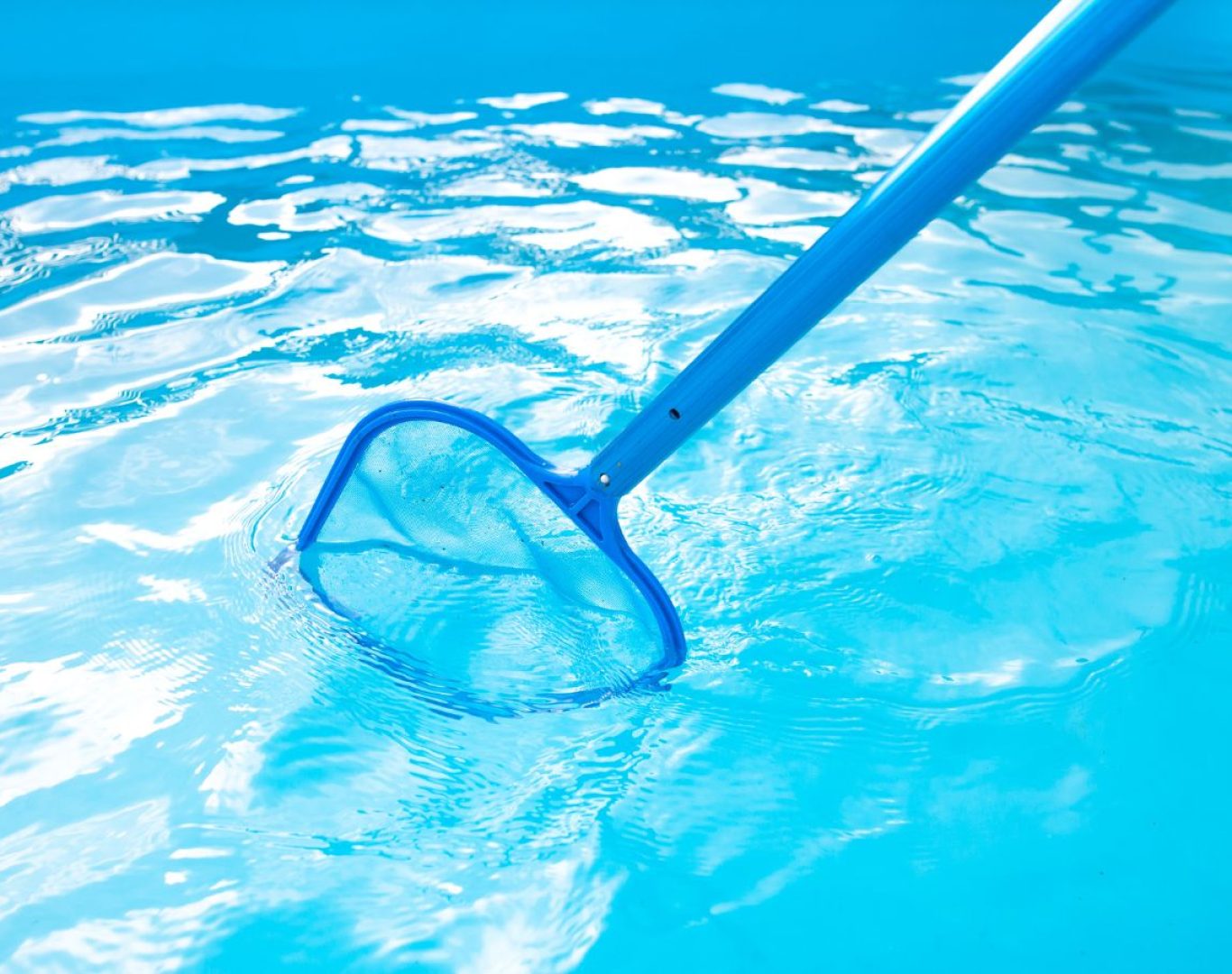 A Pool Service and Repair expert vacuuming and brushing a pool in Anaheim, CA to maintain clarity and consistent hygiene.