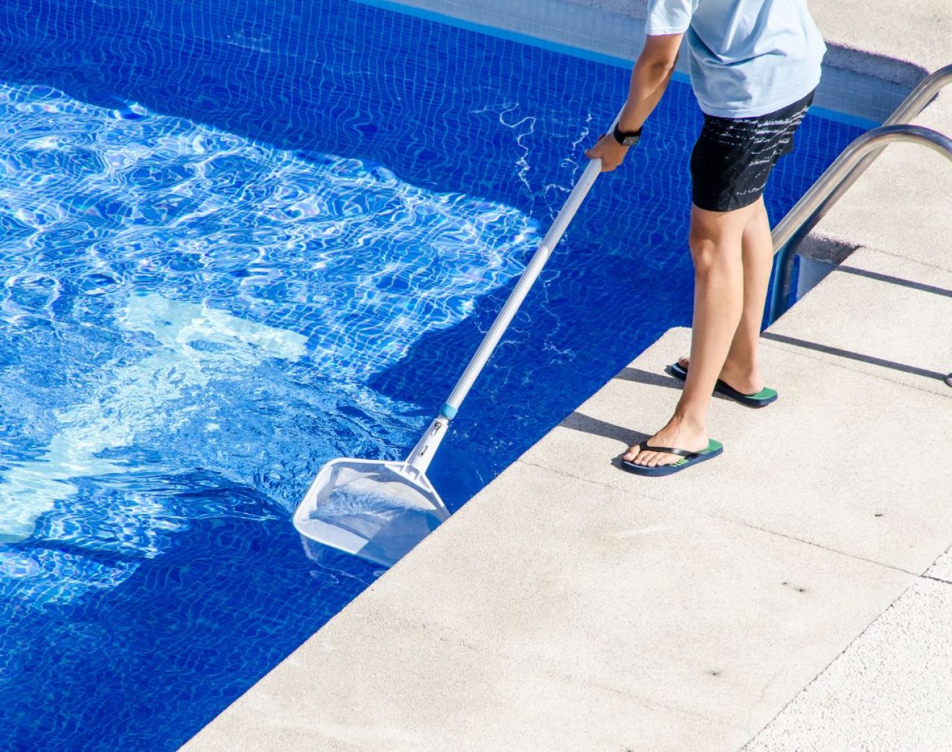 A Pool Service and Repair technician brushing and vacuuming a residential pool in Yorba Linda, CA to maintain hygiene, clarity, and water balance.