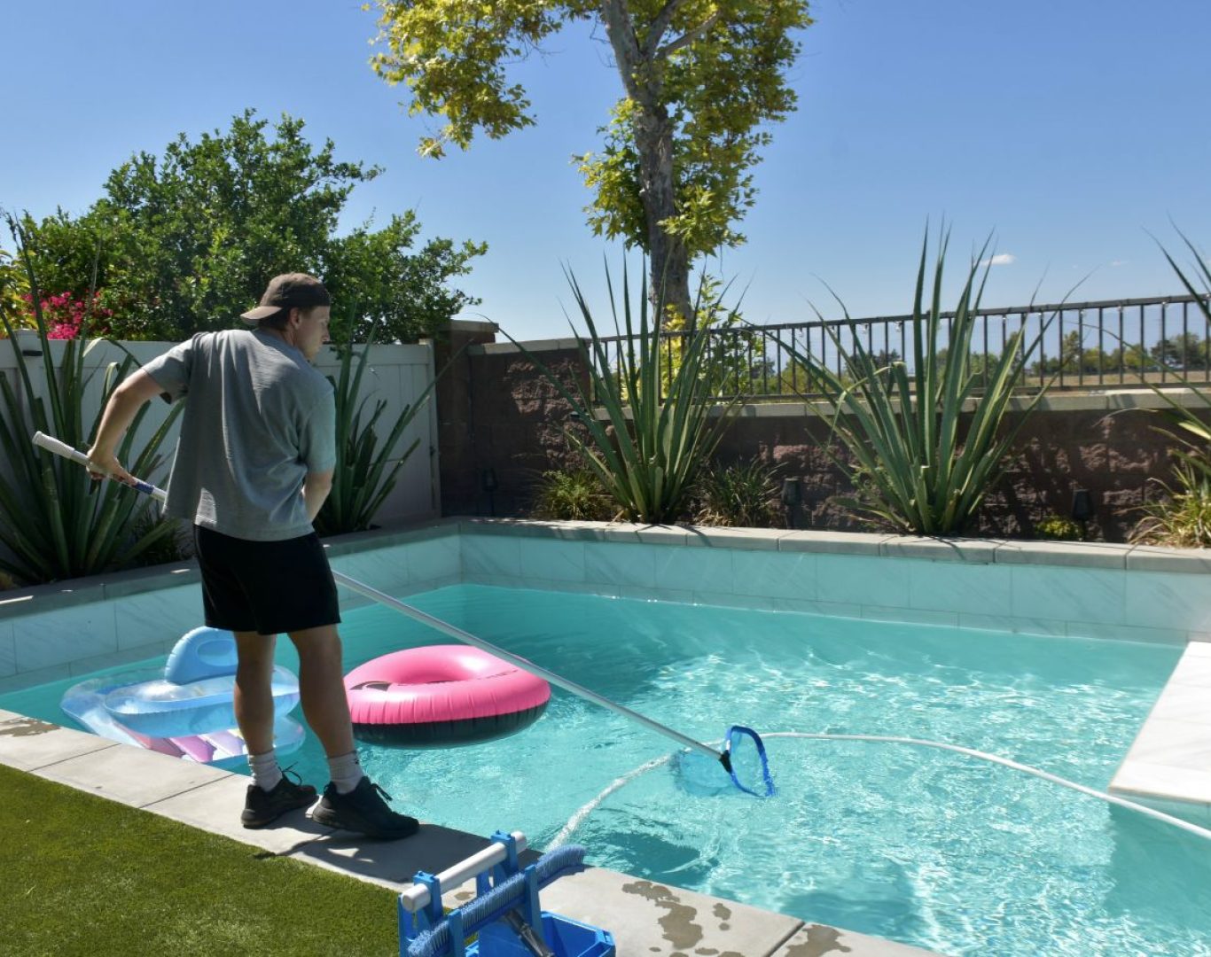A Pool Service and Repair team member replacing a pool pump in an Anaheim Hills, CA backyard, emphasizing local professional advantage.