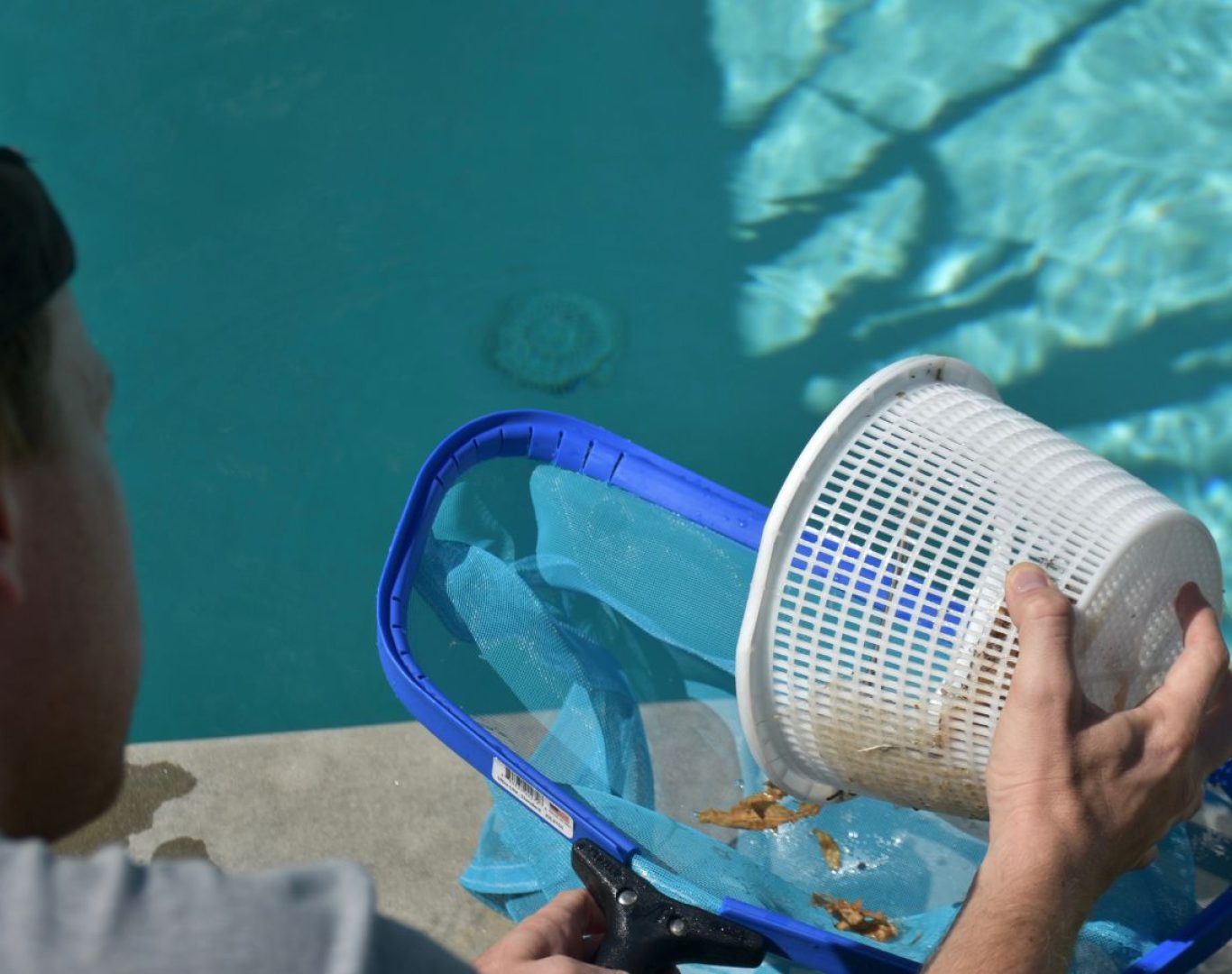A Pool Service and Repair crew replacing a pool heater in a Lake Forest, CA backyard, highlighting the value of local, experienced repair service.