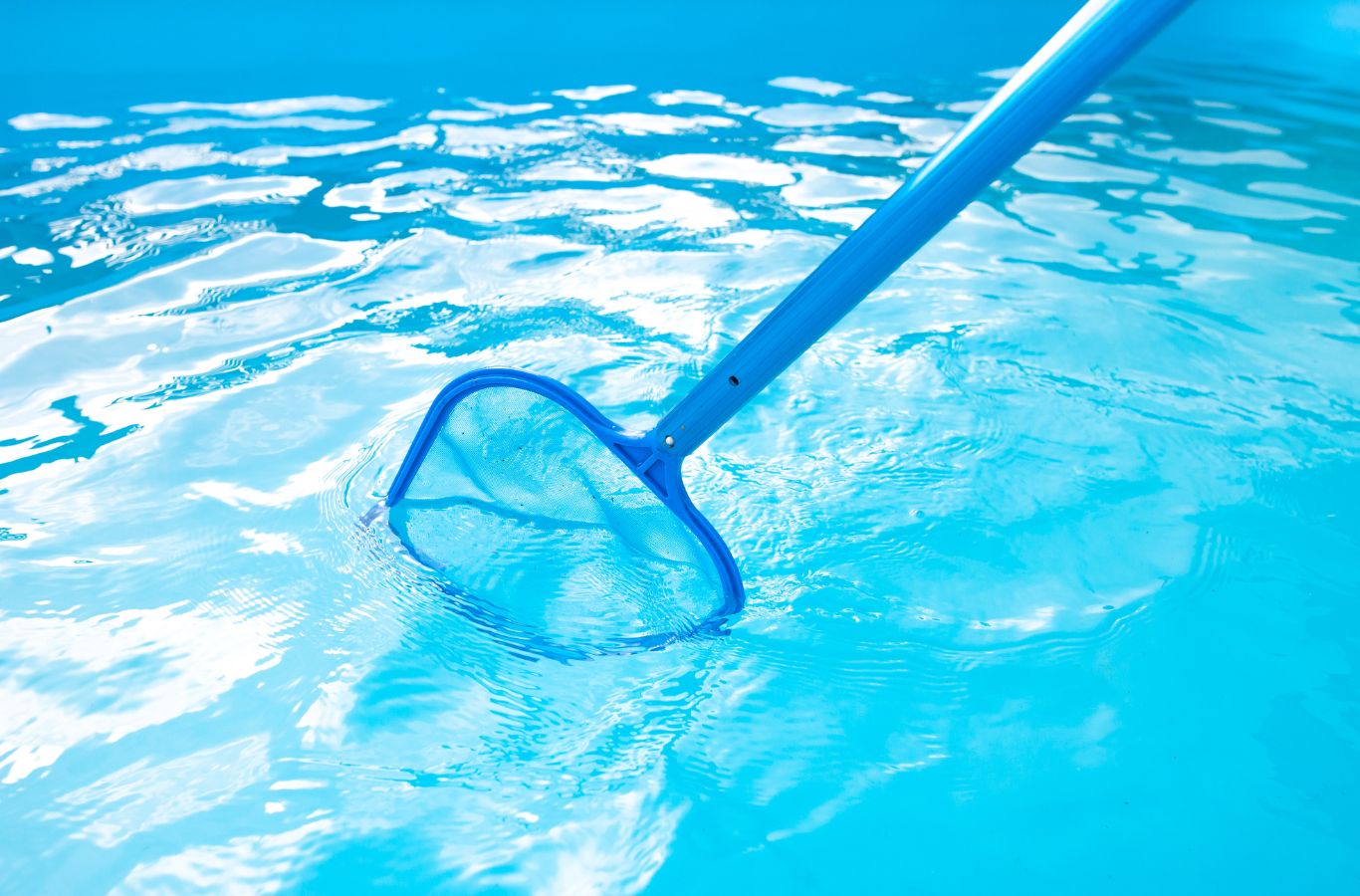 A Pool Service and Repair expert vacuuming and brushing a pool in Anaheim, CA to maintain clarity and consistent hygiene.