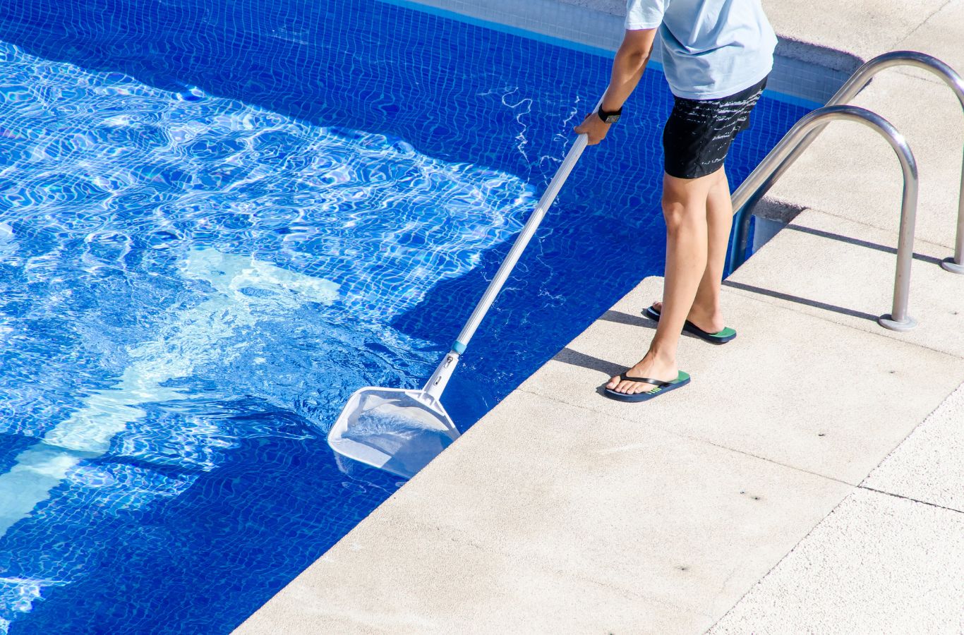 A Pool Service and Repair technician brushing and vacuuming a residential pool in Yorba Linda, CA to maintain hygiene, clarity, and water balance.